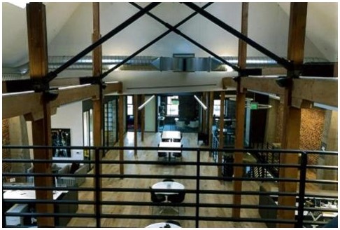 After: view of open second floor from gable roof mezzanine with added structural reinforcement visible